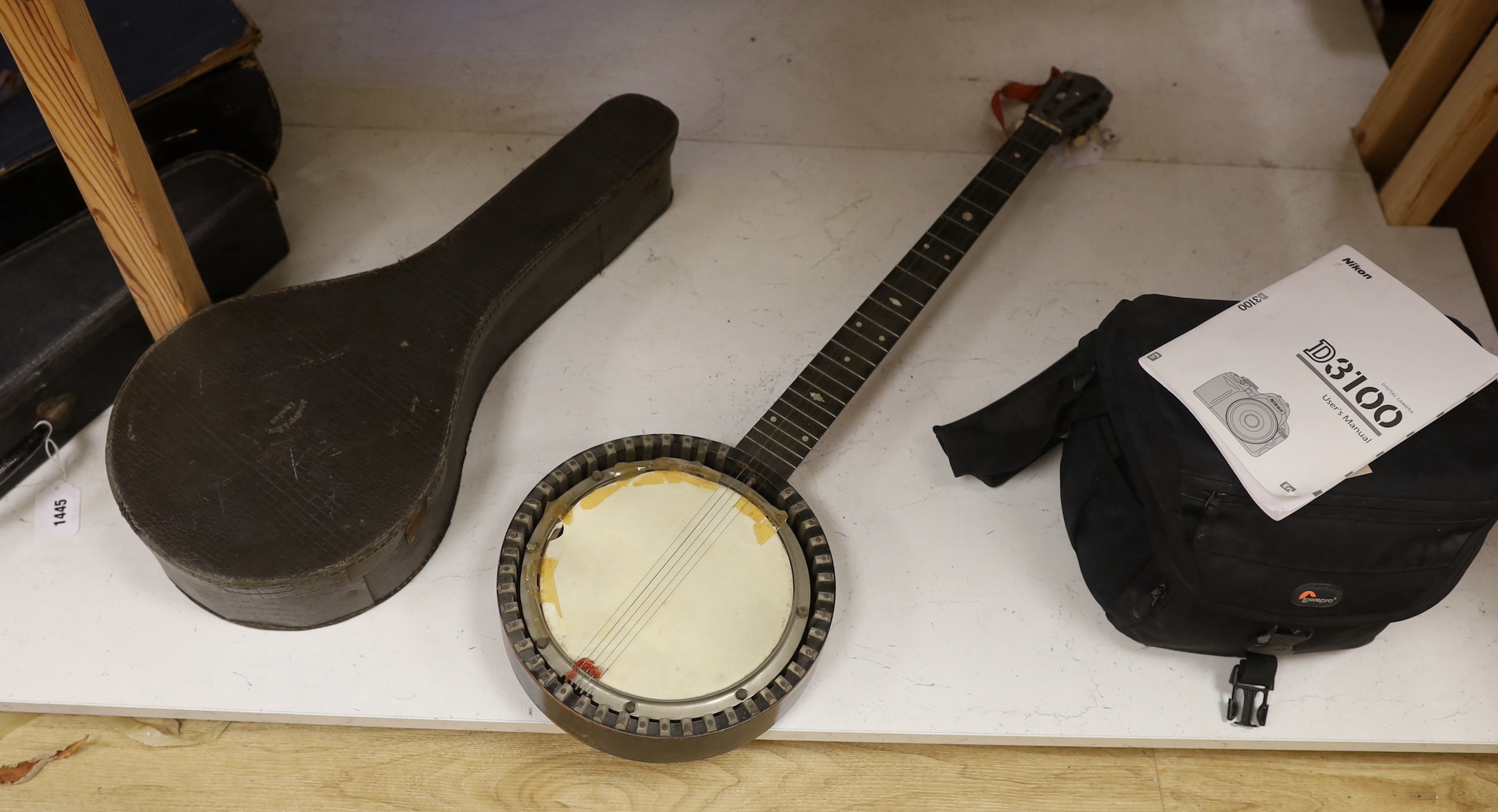 Four various banjo's, one cased together with a cased mandolin